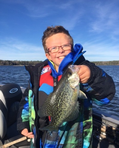 child holding up fish